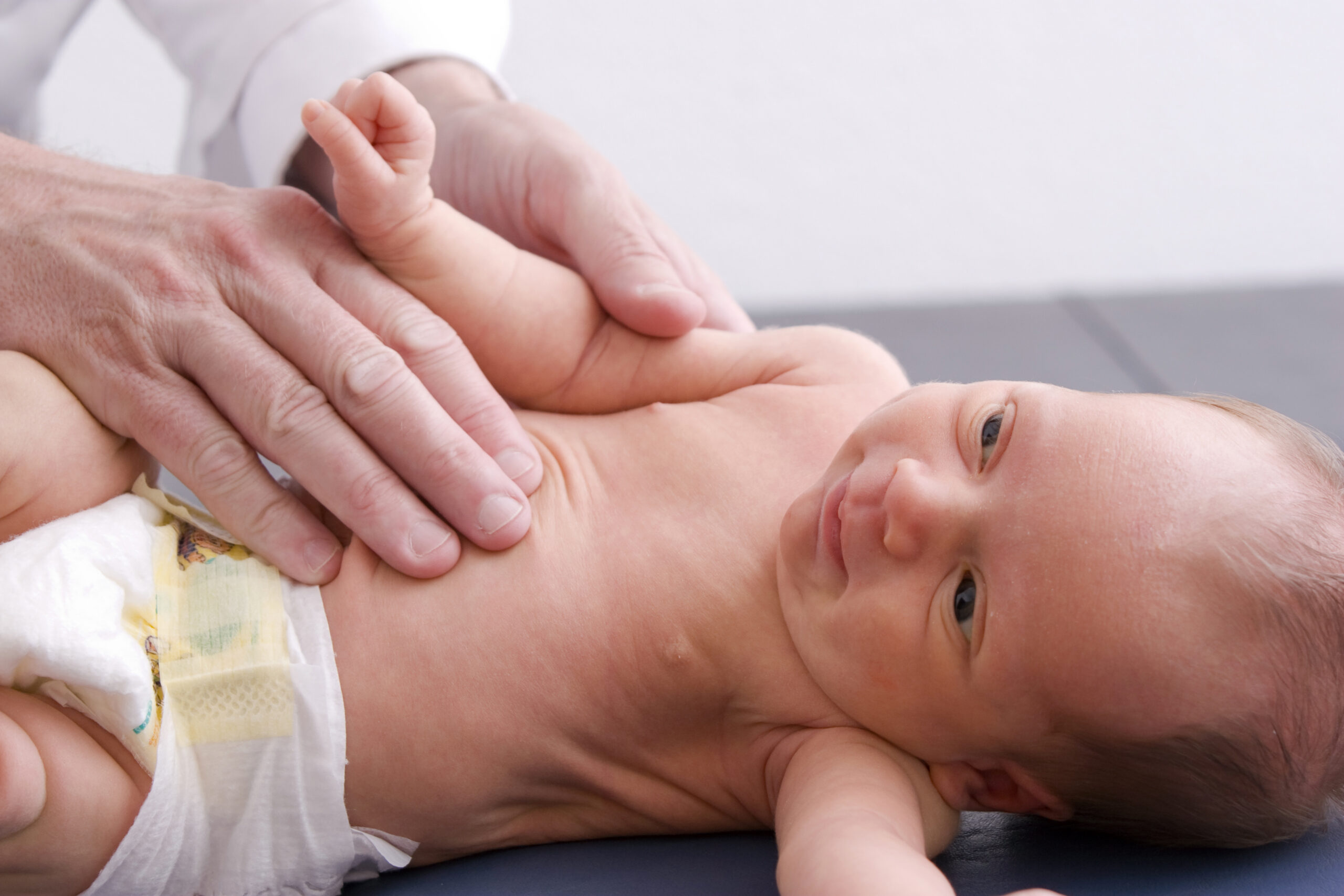 Little newborn baby getting checked out by her pediatrician.